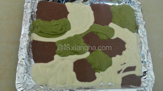 然后三个颜色蛋糕糊分别装入裱花袋，烤盘铺上锡纸，三个颜色蛋糕糊交替挤在烤盘上！