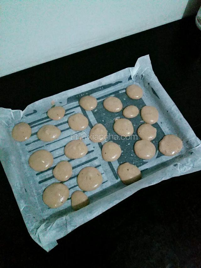 将烤盘铺好油纸，用勺子将可可糊随便倒在烤盘上