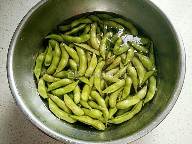 毛豆双手捧着搓洗几遍后，加半茶匙盐泡半小时。