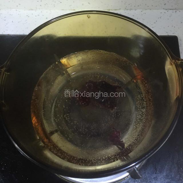 取干净透明锅，加400ml水，烧开放洛神花和冰糖煮5分钟；