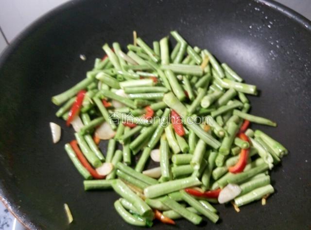 下豆角继续翻炒，豆角不容易熟，