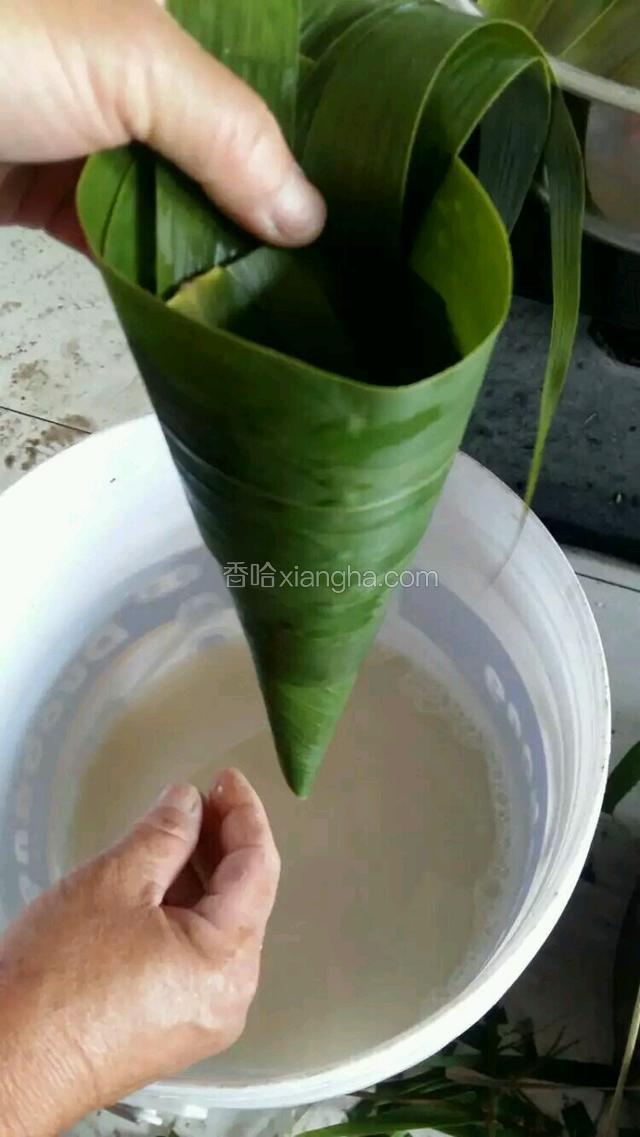 同样的手法加入三片粽叶，粽筒既成。