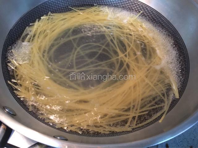 另起锅水烧开放入适量的盐，再放入意大利面，用筷子绕圈让意大利面散成如图的样子！煮至面中心没有白心表示煮好了！