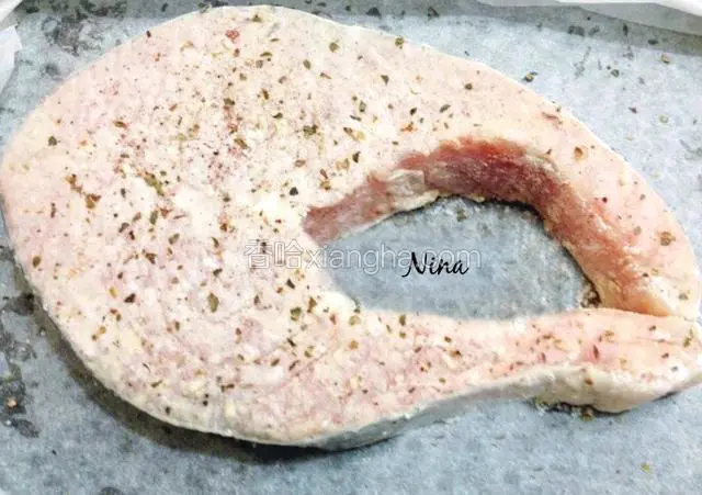 放入冰箱冷藏30分钟，让鱼入味。

提前预热烤箱200度。从冰箱取出腌好的三文鱼，表面撒少许披萨草和蒜末，入烤箱烤20分钟左右。
