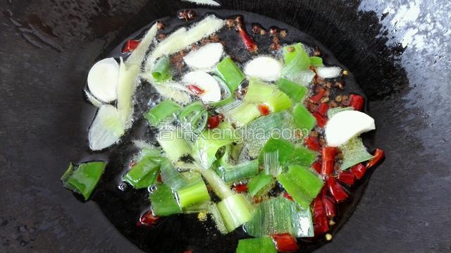 再把葱，姜，蒜，红辣椒放入锅中煸香。