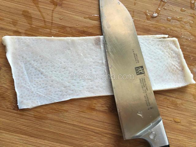 泡好的猪皮两面均用刀刮干净，再用清水清洗干净。