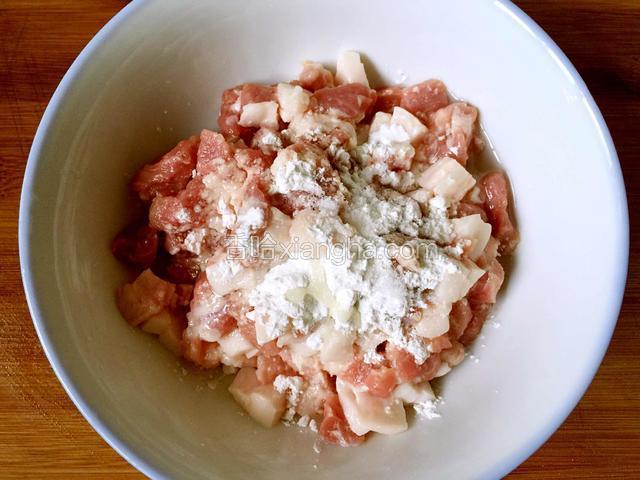 碗内放入切好的肉丁，加少许盐，料酒，淀粉，油，拌匀后腌制片刻。