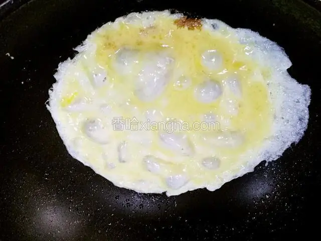 油热倒鸡蛋液，像烙面饼一样摊的薄薄一层，烙好盛出备用，