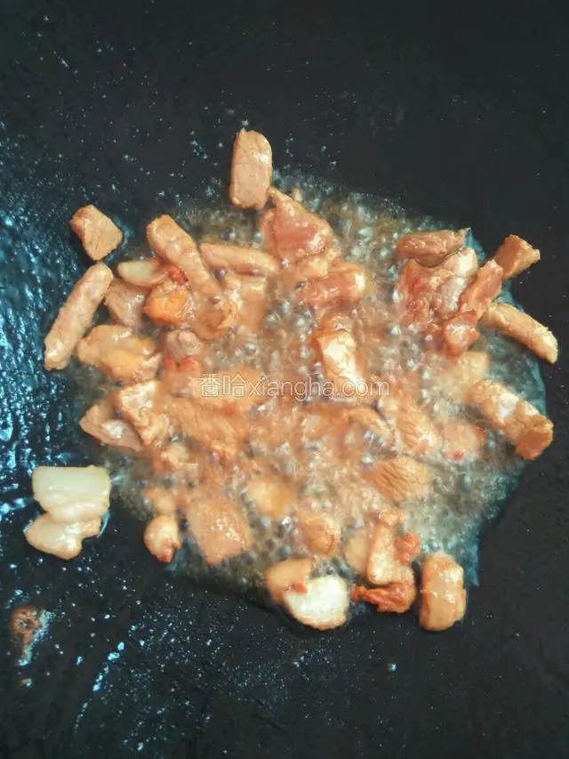 锅中下油烧热，下肥的猪肉爆油，下瘦肉，炒至变色盛起备用