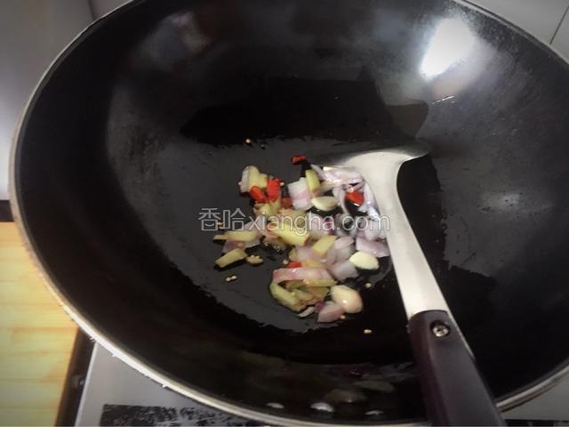 炒锅热油，依次放入生姜碎，干红椒，洋葱及大蒜子