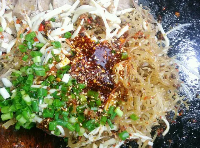 把炒香的调料放进猪心盆里，加孜然油泼辣子，（孜然油泼辣子是我自己做的，以前有菜谱。）花椒粉，酱油，醋，味精，葱拌匀。