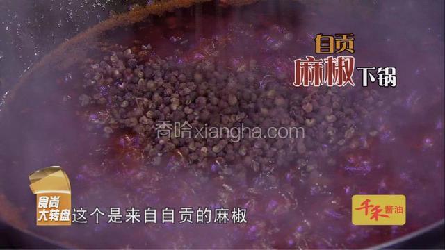 糍粑辣椒加红油，倒入锅中，再加入自贡麻椒、花椒、干辣椒、大量醪糟。 