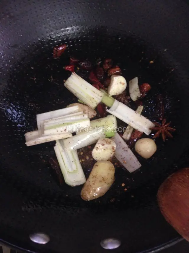 锅里放油小火爆香辣椒花椒等，然后加入葱姜蒜爆香