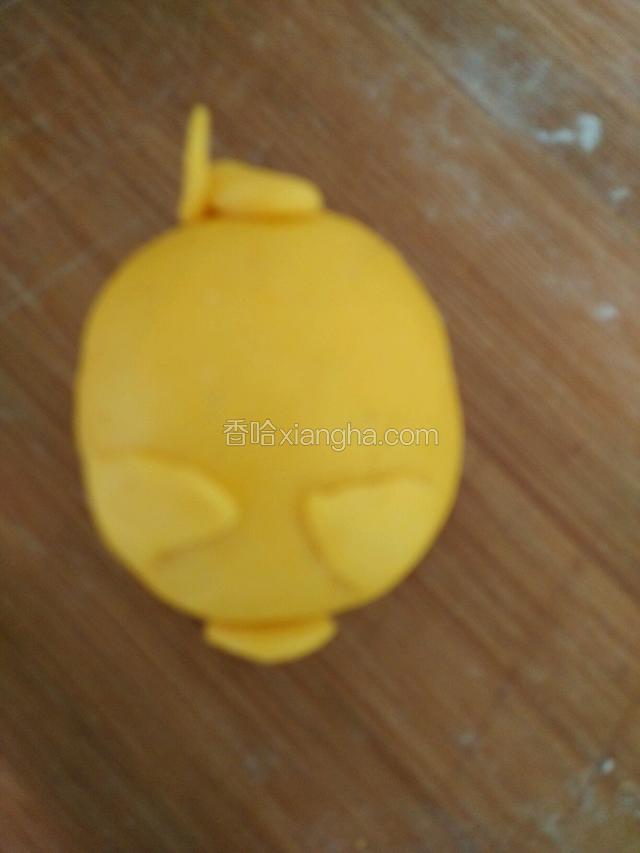 帖在小猪的头部，再从小面团上揪下面做出鼻子和尾巴沾上。