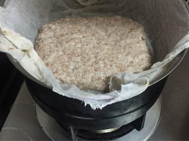 锅里烧水，放入蒸格，准备一块纱布，把肉泥匀铺在纱布上，摔打、压实，放入锅中，蒸熟