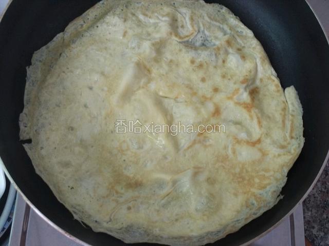蛋液凝固得差不多就翻个面煎另一面（翻面的时候用拇指，食指捏一点蛋皮和锅铲一起慢慢翻面）