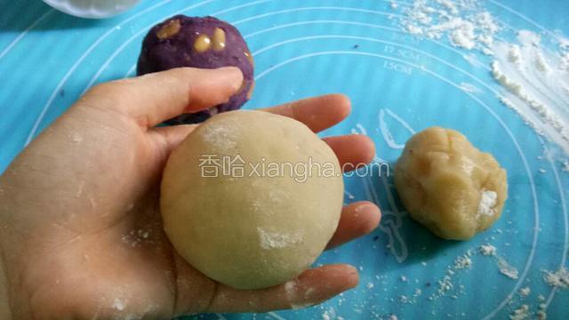 包好馅的团子抹上一层面粉，模具也装进面粉晃一下，倒出剩余的，然后将团子放进去压出形状跟花纹。