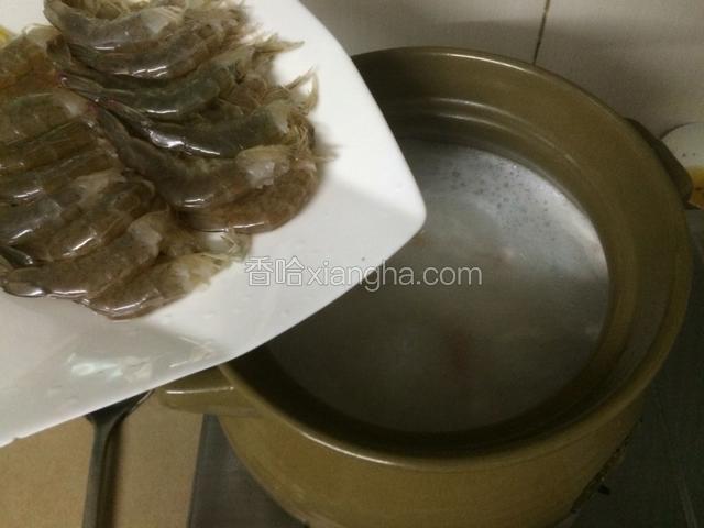 大约5分钟后，粥已经完全开花后，倒入鲜虾，熬煮2分钟左右，