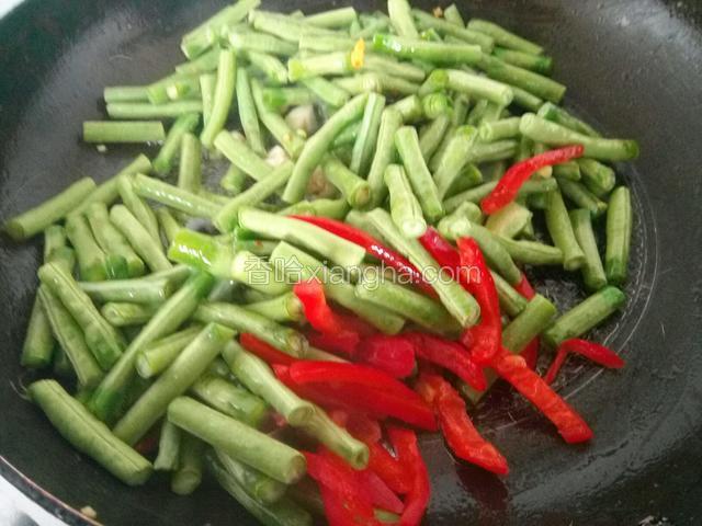 锅热油爆香蒜，倒入缸豆红辣椒翻炒
