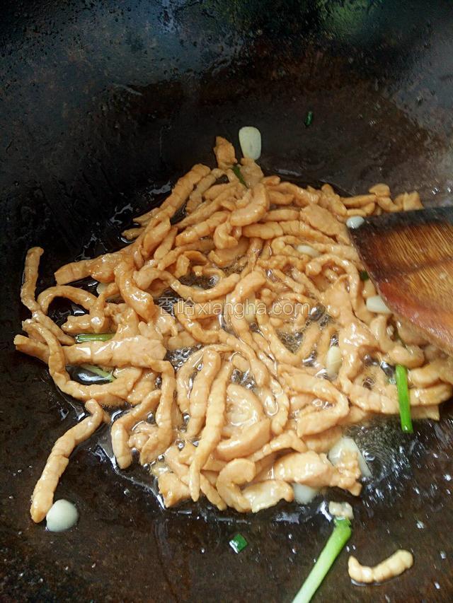 锅中放油烧热把葱蒜爆香加入肉丝炒至断生