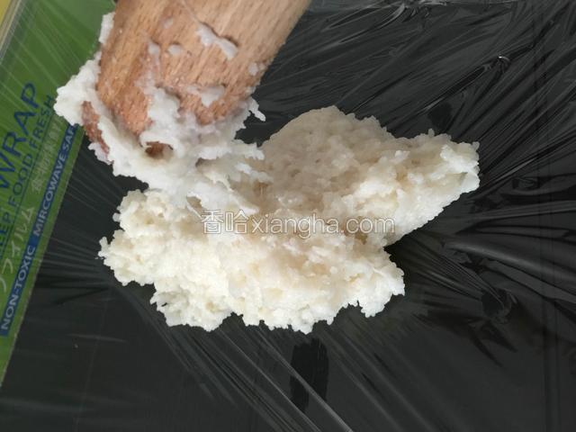 把舂好的糯米倒出在铺有保鲜膜的桌子上