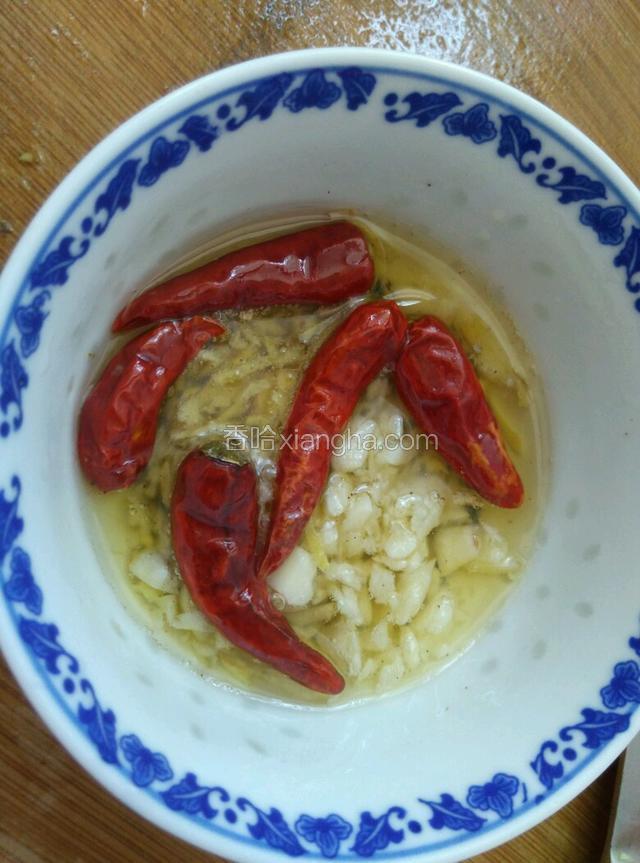 把热油倒入装有姜、蒜、干红椒的碗里，利用热油把红椒炸香（能吃辣的把辣椒剪碎，我怕小孩吃不了太辣，所以整个用）。