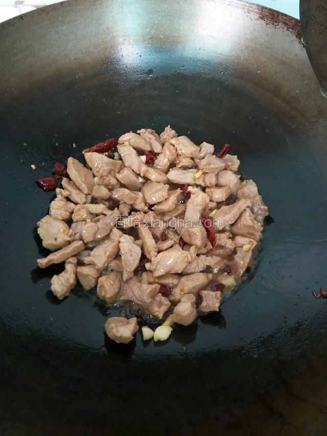 再把肉丁倒进锅煸炒均匀