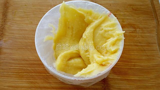 裱花袋中装入八齿裱花嘴套在杯子上，把面糊倒入裱花袋中。