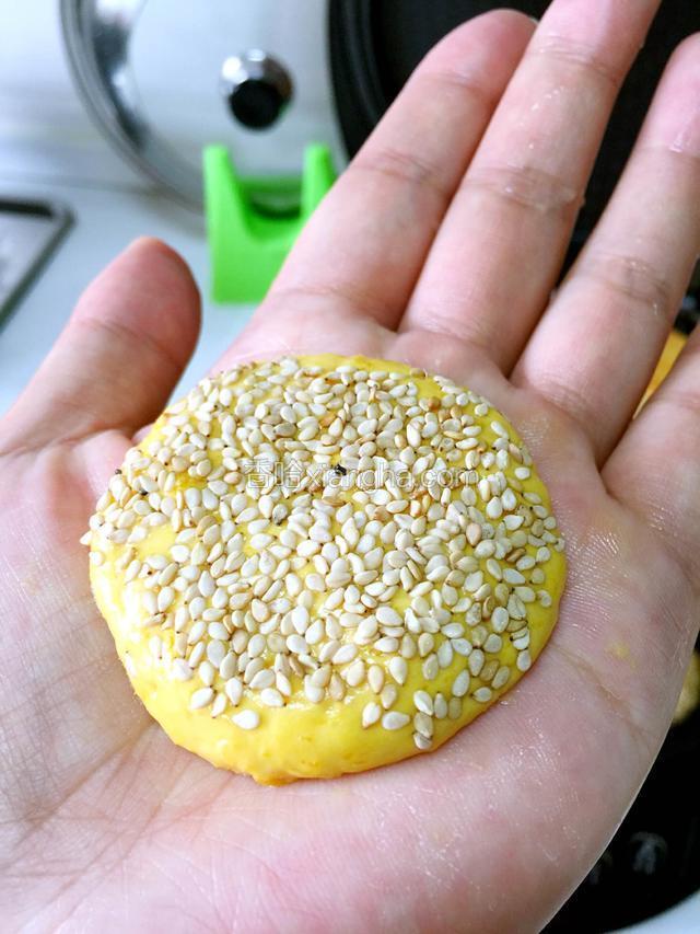 取一块拍成饼状，粘芝麻
