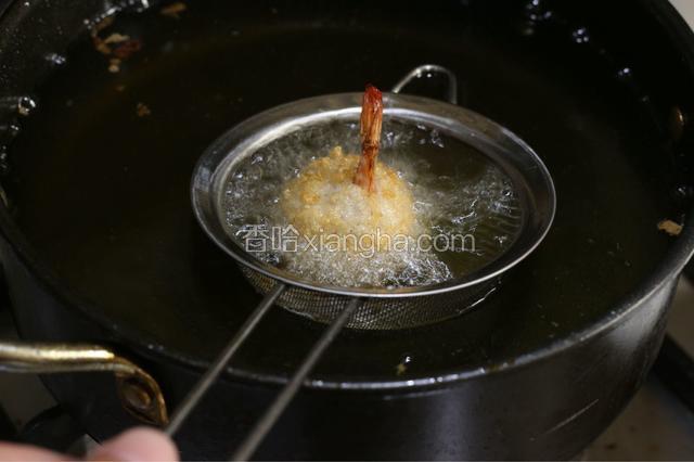 油炸锅倒油烧热，加入裹好粉的虾，中小火炸透至虾球上浮，捞出后猛火再炸一次。表面金黄，捞出控油。