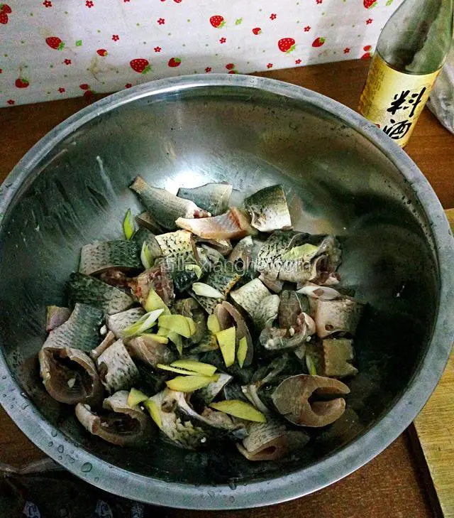 先放入酸菜鱼调料里的白色包，是专门腌鱼的，我步骤图第一张里有。然后放入葱姜蒜腌制，再倒入大概5勺料酒去腥！