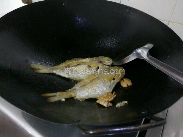 把鱼两面煎制金黄，