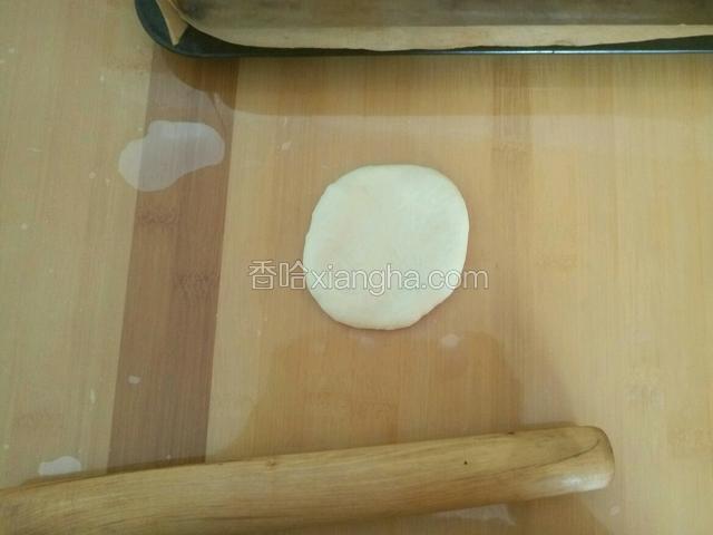 将一个面团用擀面杖擀薄 