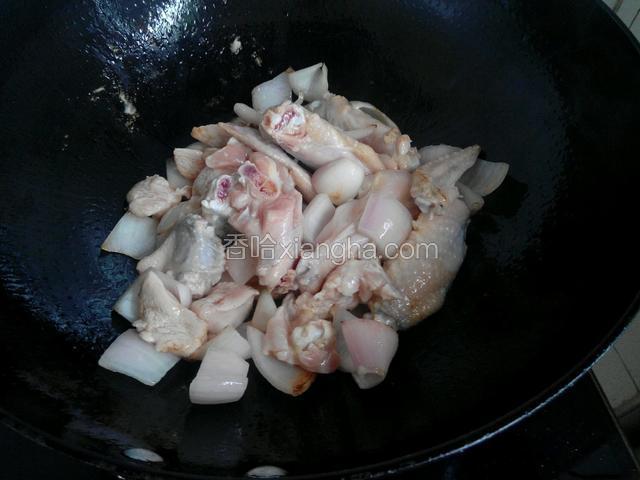 锅内倒适量的油，烧热后放入洋葱块炒香，再放入腌好的鸡翅