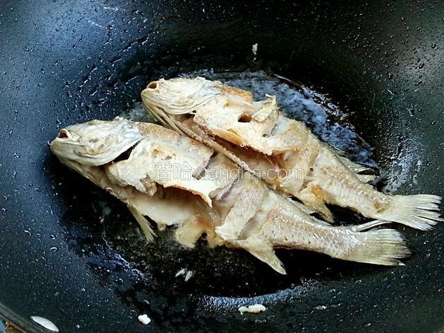 一面煎好后，翻面煎，两面煎好后，将鱼夹出，油留锅内