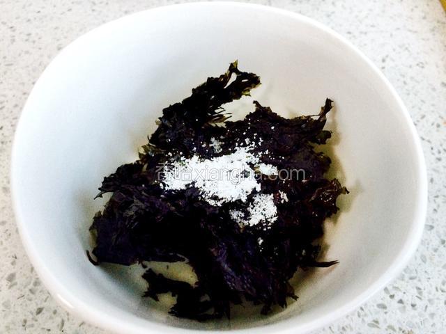 把紫菜撕开，加入两滴香油和适量的盐。