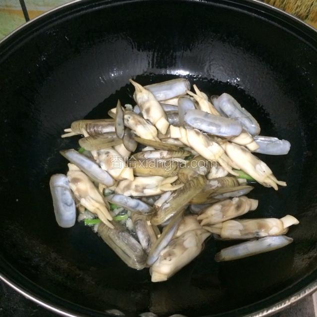 接着把洗好沥干的海蛏倒入，大火爆炒。