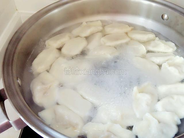 盖上锅盖煮至沸腾，浇些凉水用木铲轻轻搅几圈，盖上锅盖，几分钟后饺子都浮在水上关火，捞出