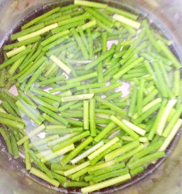 锅里烧水，水开后倒入蒜苔，然后滴几油，煮至蒜苔颜色变绿后就捞出来。