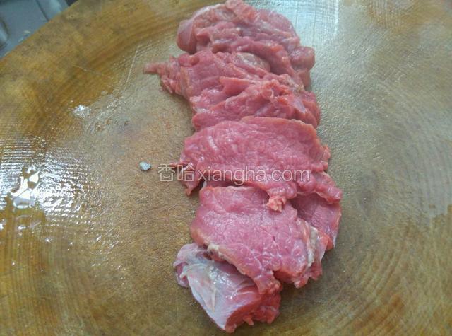 先把牛肉顺着横纹切大片。