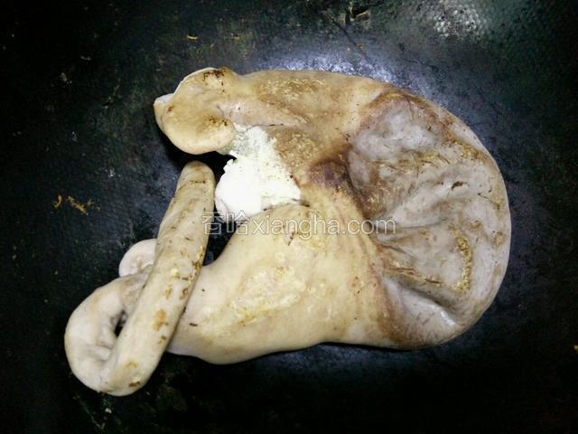 大火把炒锅烧热，放入洗好的猪肚，借助锅铲按住猪肚用力在锅里擦，猪肚烧干表面水份，（看上去脏的都沾锅上了吧）这样就可以拿出来了