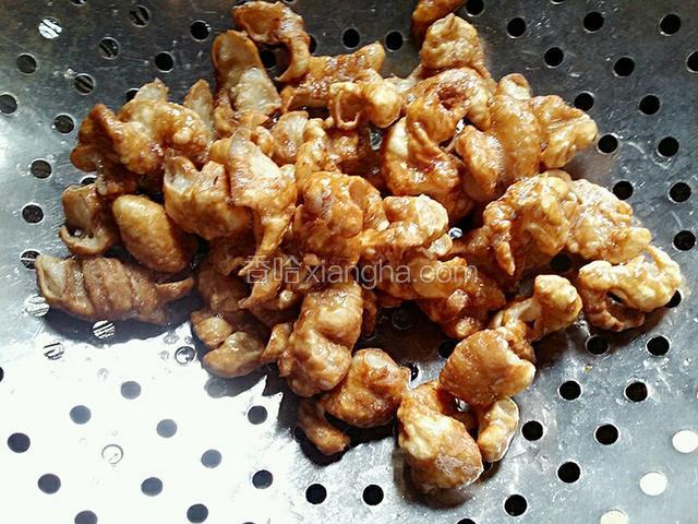 肥肠炸至成焦黄色时，调微火，把肥肠捞出沥油备用。