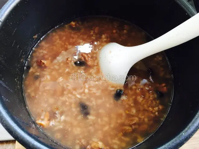 粥煮好后用勺子搅拌一下。