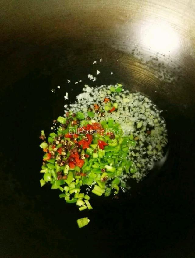接着加入切好的青椒、红椒，适量花椒一起翻炒。