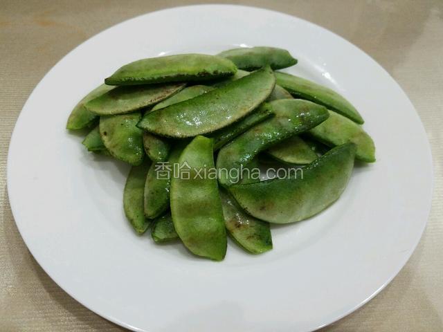 将扁豆的两头和豆筋摘掉，泡水中二十分钟后捞出来沥干水备用。