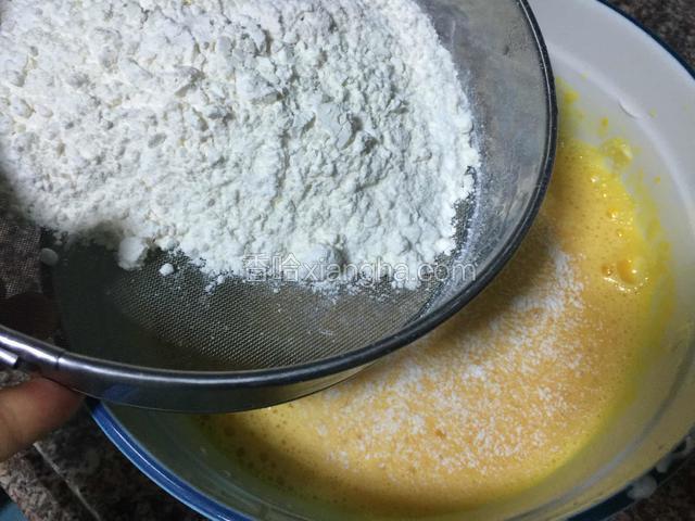 把低筋蛋糕粉筛入蛋黄糊里。