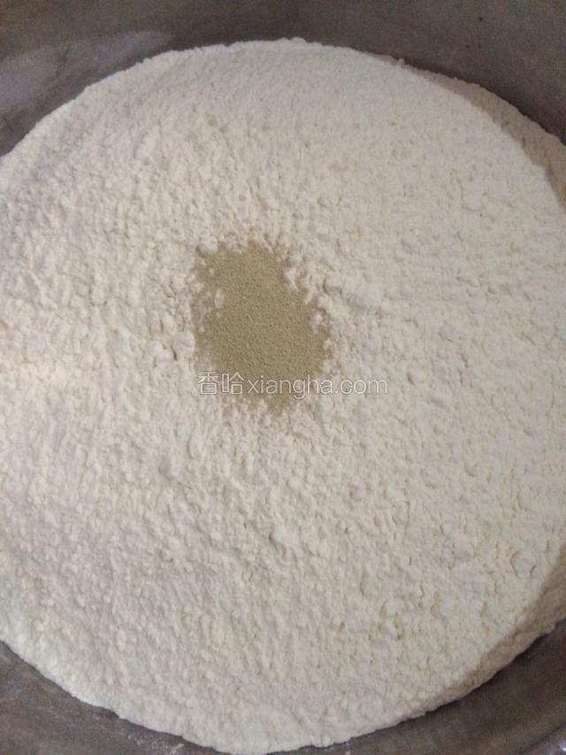 面粉放入盆内，倒入一包酵母。