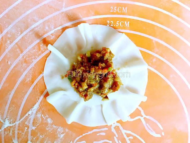 开始做烧麦：在烧麦皮中间放适量的馅