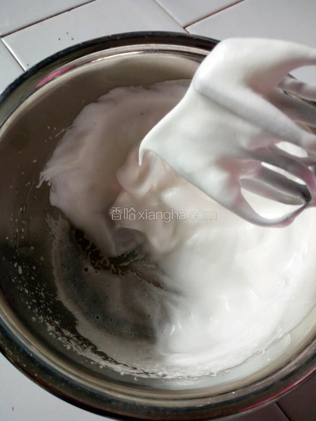 取蛋清加入剩余的细砂糖，一起打发至湿性发泡，即提起有小弯勾。
