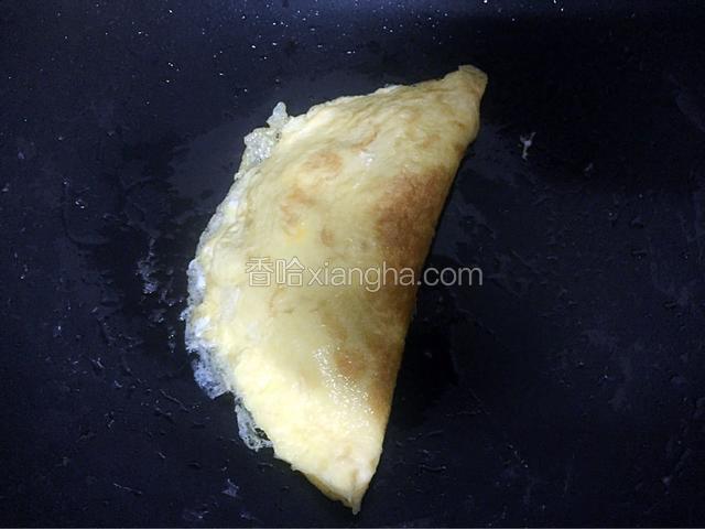 然后用锅铲轻轻的把另一半的鸡蛋折起盖上，然后用锅铲轻轻压实一下，再煎一下使其鸡蛋收口紧实后即可出锅
